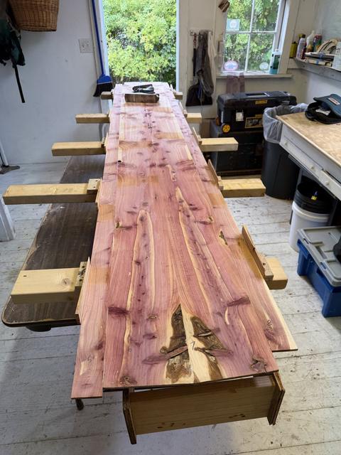 Nine feet of deck plank, board by board, clamped down and left to set.