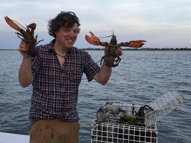 Two lobsters and a big grin.