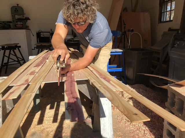 Every strip gets a feathered edge by hand, so the glue-up closes without a gap.