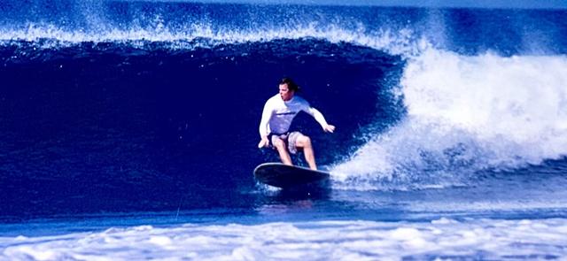 An earlier wooden board, in the water.