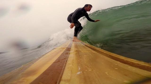 The view from the nose of a wooden board.