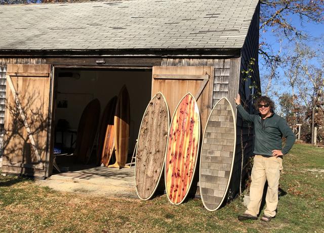 Three boards, three textures: bark, cedar, and shingle, lined up at the barn door.