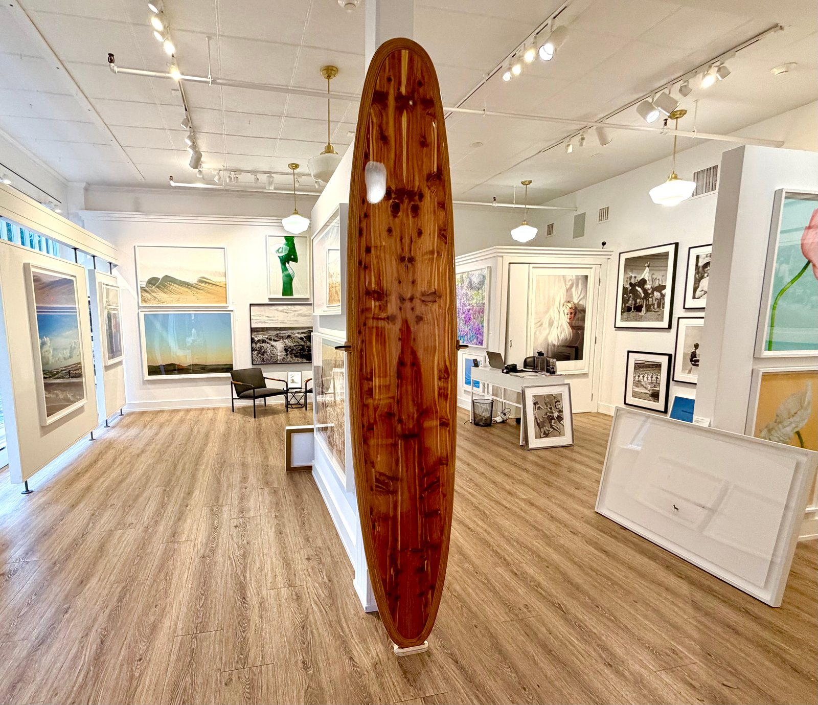 The finished cedar board standing on its stand in the middle of a bright gallery